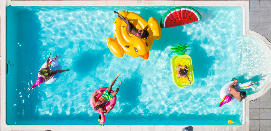 Overhead view of 5 people floating in pool